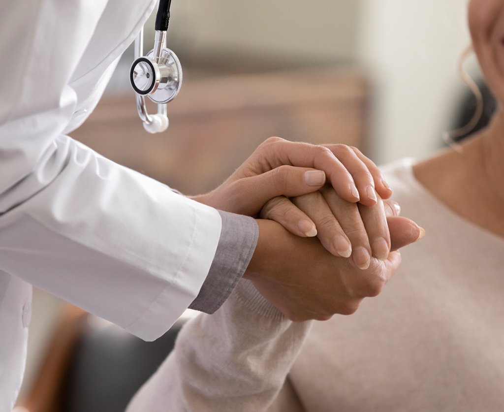 Doctor holding patient's hand