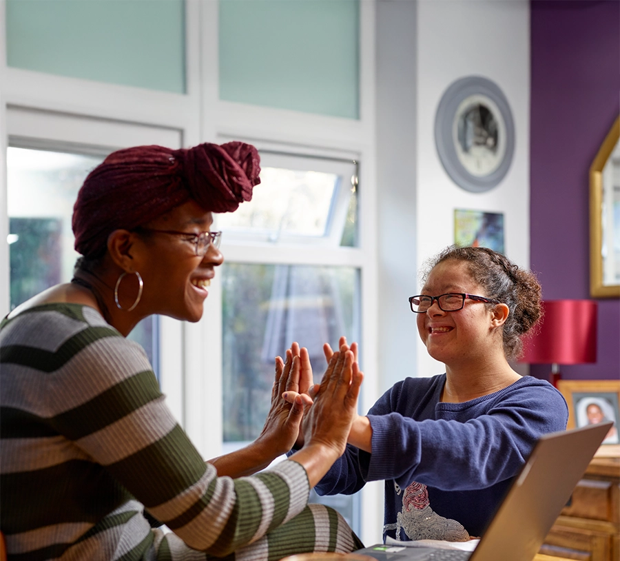 mother and daughter giving each other a high five.